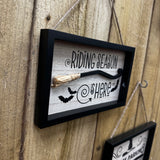 Halloween Broomstick hanging sign 21x14cm a black and wood framed with 3D miniature broomstick &amp; textured straw brush tied to the end
Quote - 'Riding Season is Here' with images of bats flying&nbsp;