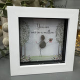 Pebble Art by La De Da Living&nbsp;

Award winning keepsake gifts - Handmade in the Cotswolds&nbsp;

Mini Glitter Framed Pebble Art - White block square frame 12.5cm
Image - Pebble person holding flowers and two blossom glitter trees either side with flower beds &amp; butterflies..&nbsp;
Quote - 'You are one in a million'
