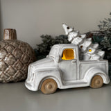 Neutral glazed Ceramic LED Car carrying a christmas Tree on the roof