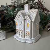 Neutral glazed Ceramic LED detailed small House H11cm and lots of windows to light up when switched on..
