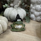 Hop to it this Autumn;
Small detailed Green ceramic frog wearing a black wizard hat and a cheeky smile 6.5cm