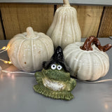 Hop to it this Autumn;
Small detailed Green ceramic frog wearing a black wizard hat and a cheeky smile 6.5cm