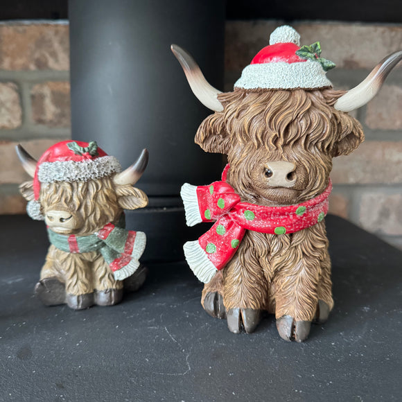Christmas Highland Cow wearing a hat with holly seasonal scarf with a little sparkle
Available in 2 sizes - Small H10.5cm & Large H17cm