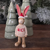 Christmas&nbsp;Ruth Rabbit Figure H14cm dressed in a Beige knitted jumper with the words in red text 'NICE' and wearing a santa hat.&nbsp;

New AW26