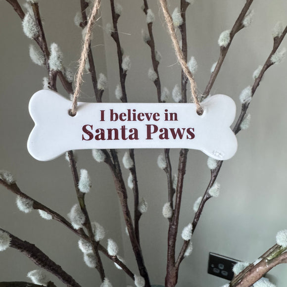 Small Ceramic white glazed bone shaped hanging sign 11x4cm
Quote - ‘I believe in Santa Paws’