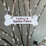 Small Ceramic white glazed bone shaped hanging sign 11x4cm
Quote - ‘I believe in Santa Paws’