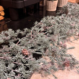 Artificial frosted pine garland dotted with small, realistic pinecones with downward draping cascading needles L183cm