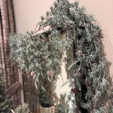 Artificial frosted pine garland dotted with small, realistic pinecones with downward draping cascading needles L183cm