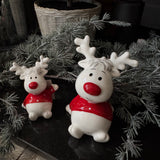 Christmas - Glazed Ceramic White sitting Reindeers wearing a Red spotty jumper and with a Red nose
Available in two sizes; - Small 9cm &amp; Large H12cm