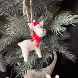 Christmas ceramic hanging decoration
Glazed White Ceramic Reindeer wearing a Red &amp; white striped knitted Scarf &amp; matching bobble hat with a big smile &amp; red button nose 8cm