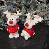 Christmas ceramic hanging decoration; White Reindeer wearing a Red spotty jumper and with a Red nose
Available in two positions - Sitting H6cm &amp; Standing H8cm