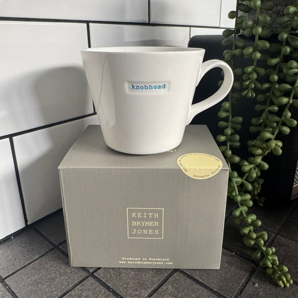 Keith Brymer Jones Word Range Medium Bucket White Porcelain Mug 350ml with handstamped quote
Colour font - Blue
Quote - knobhead