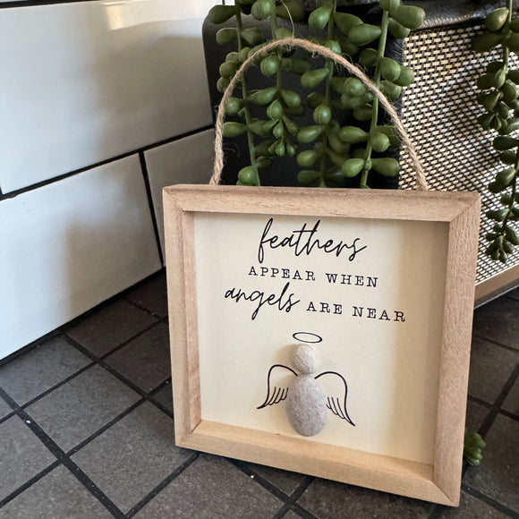Small Hanging Wooden 13cm square Sign
Quote as follows; 'feathers appear when angels are near'
Illustration of a Pebble Angel with wings & halo 