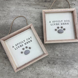 Hanging Wooden Pebble Sign - 'A spoilt cat lives here'