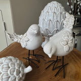 Glazed neutral Ceramic Standing Bird Ornament With Texture Detail and iron legs
Available in two styles - looking down H14.5cm &amp; looking upwards H12.6cm