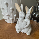 Glazed Ceramic Neutral Rabbits stood together holding a heart H14cm&nbsp;