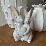 Glazed Ceramic Neutral Rabbits stood together holding a heart H14cm&nbsp;