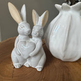 Glazed Ceramic Neutral Rabbits stood together holding a heart H14cm&nbsp;