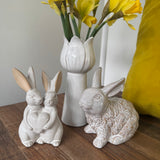 Small neutral Rabbits holding a heart