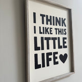 Quotable hanging wooden framed sign 40cm;
Quote in bold black text on white vinyl 'I Think I like this little life'