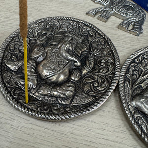 Metal Round 10cm dia Embossed Incense Stick Holder&nbsp;

Design - Ganesha the Hindu elephant god with 4 arms