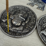 Metal Round 10cm dia Embossed Incense Stick Holder&nbsp;

Design - Ganesha the Hindu elephant god with 4 arms