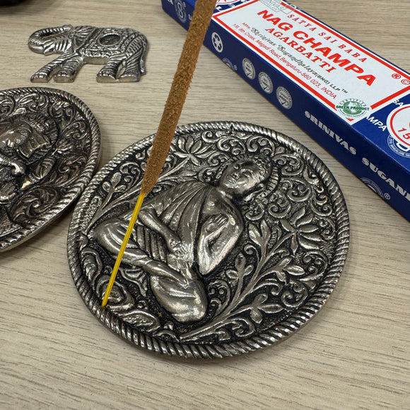 Metal Round 10cm dia Embossed Incense Stick Holder 

Design - Buddha Vitarka Mudra hand position meditating