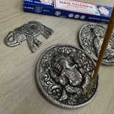 Metal Round 10cm dia Embossed Incense Stick Holder&nbsp;

Design - Ganesha the Hindu elephant god with 4 arms