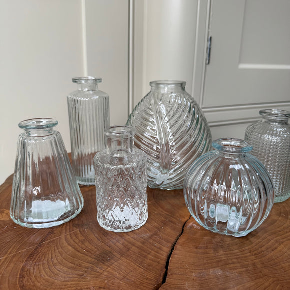 Clear Small Glass Bottle Vases
Various styles
Small Geometric Bottle H9.2cm x 5cm

Leaf bottle Vase H13cm
Round Ribbed H8.4cm
Dimpled - H10cm
Tall Slim Ribbed - H13.2cm
Ribbed wide base & narrow top - H9.9cm x W7.4cm 