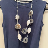 Eliza Gracious quality affordable design led branded costume jewellery

Long double strand necklace with Grey marble resin discs, matt silver oval metal discs, attached with silver slim bars and grey twine

New SS26 EG Collection
EN1057