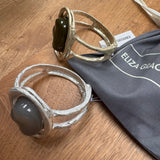 Eliza Gracious quality - affordable design led branded costume jewellery.

Hinged Bangle with large resin stone; statement piece with a beaten effect

Available in 2 colours;

Burnished Pale Gold with Olive Green resin
Matt Burnished Silver with Pale Grey resin