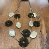 Eliza Gracious quality affordable design led branded costume jewellery

Long double strand necklace with Olive green marble resin discs, matt gold oval metal discs, attached with gold slim bars and green twine

New SS26 EG Collection
EN1057