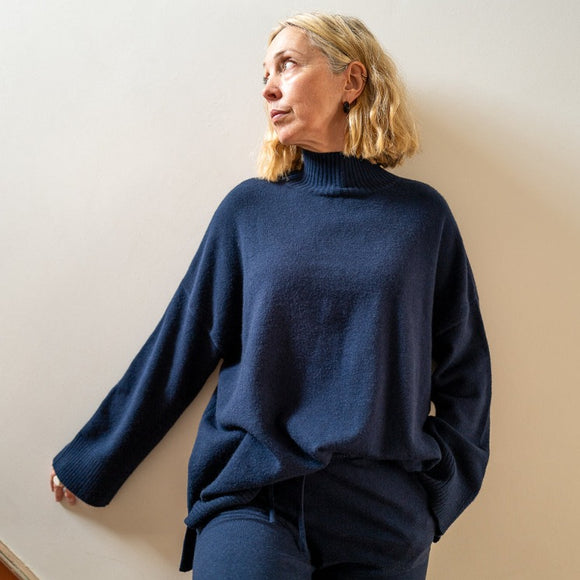 Chalk UK - The Lyndsey Jumper navy is the ideal go-to piece for all occasions. Its funnel neck and wide cuff design make it perfect for layering and easy to style both during the day and night. With a small side split, this jumper offers both style and comfort.