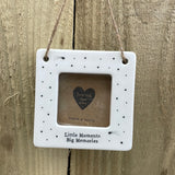 Beautiful white ceramic photo frame with star detailing all around. In the middle is space for a small photo with quote "Little Moments, Big Memories" written underneath. Hung with a jute rope.