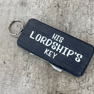 Made in the UK by Giggle Gift Co. Wooden block keyring with white text quote on both sides; 'His Lordship's Key' 