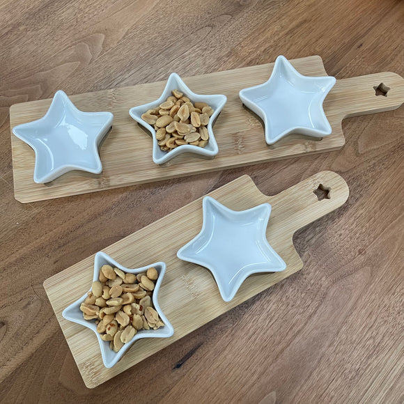 Ceramic star shaped dishes sat in grooves on a wooden serving board. They look so stylish and great when hosting a gathering at your home to place olives, nuts etc inside. Available in two sizes; 2 or 3 star