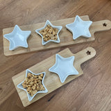 Ceramic star shaped dishes sat in grooves on a wooden serving board. They look so stylish and great when hosting a gathering at your home to place olives, nuts etc inside. Available in two sizes; 2 or 3 star