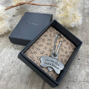 A stylish metal keyring in the shape of a bee with "you're the bees knees” on one side and raised bee stripes on the other.