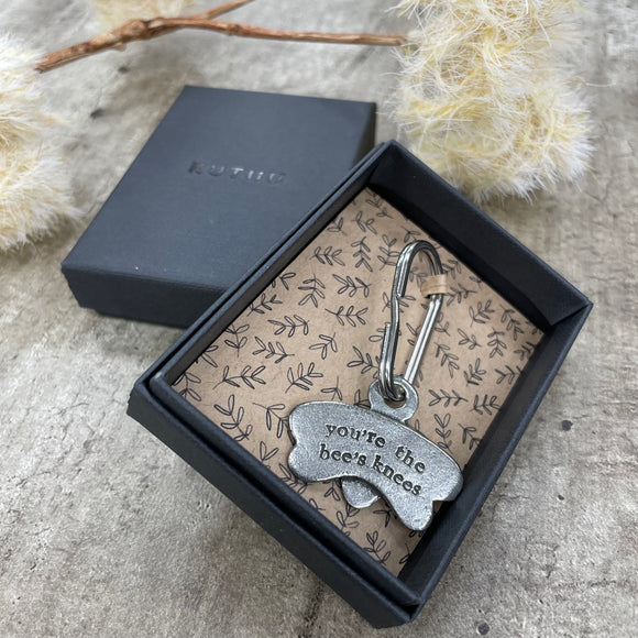 A stylish metal keyring in the shape of a bee with 
