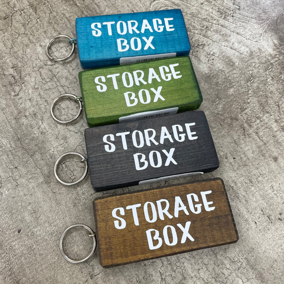Made in the UK by Giggle Gift Co. Wooden block keyring with white text quote on both sides; 'Storage Box' 