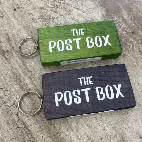 Made in the UK by Giggle Gift Co. Wooden block keyring with white text quote on both sides; 'The Post Box' 