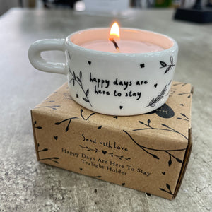 Ceramic T-Light Holder with loving quote: 'Happy days are here to stay' Lovely small gift idea for that special someone to show them you are thinking about them in a simple yet beautiful way. Decorated with branches & hearts all around and a handle at the side.