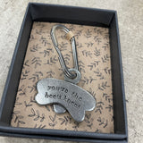 A stylish metal keyring in the shape of a bee with "you're the bees knees” on one side.