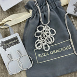 Eliza Gracious quality affordable design led branded costume jewellery.  Bunch of Rings Silver Long Necklace with earrings to match