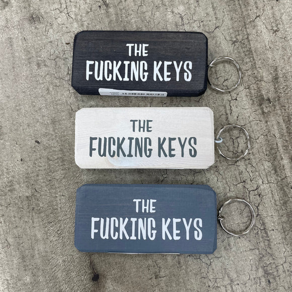 Made in the UK by Giggle Gift Co. Wooden block keyring with white text quote on both sides; 'The Fucking Keys'    BEST SELLER