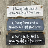 Made in the UK by Giggle Gift Co. Wooden L29.5cm Hanging Sign "A lovely lady & a grumpy old git live here!" MP060