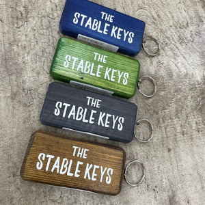 Made in the UK by Giggle Gift Co. Wooden block keyring with white text quote on both sides; 'The Stable Keys' 
