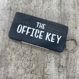Made in the UK by Giggle Gift Co. Wooden block keyring with white text quote on both sides; 'The Office Key' 
