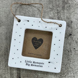 Beautiful white ceramic photo frame with star detailing all around. In the middle is space for a small photo with quote "Little Moments, Big Memories" written underneath. Hung with a jute rope.