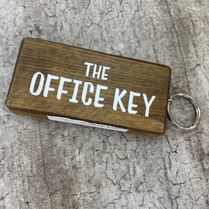 Made in the UK by Giggle Gift Co. Wooden block keyring with white text quote on both sides; 'The Office Key' 